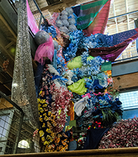 A fiber collage installation cascading down a stairwell